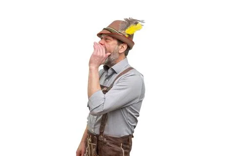 Bearded man in Bavarian hat shouting sideways isolated on light background 写真素材