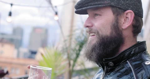 Bearded man with beer talks and laughs in Downtown LA at dusk 4K Stock Footage 63498664
