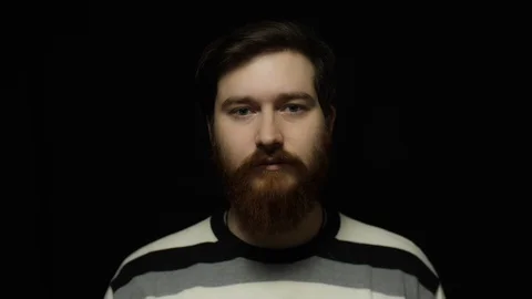Bearded man on black background Stock Footage 128607731