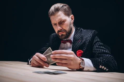 Bearded Man With Bow Tie Checking Poker Hand Stock Photos