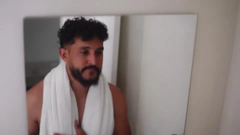 Bearded man brushing his teeth in bathroom Stock Footage 336975012