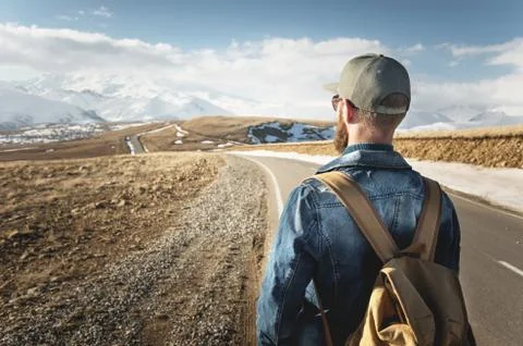 A bearded man in a cap with a backpack ready to go a long way. A man on a Stock Photos
