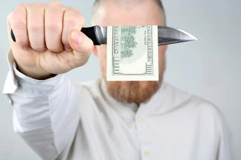 Bearded man closes a dollar bill and a knife face Stock Photos