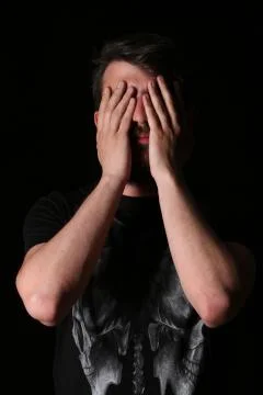 Bearded man closing blind. Close.up. Black Stock Photos