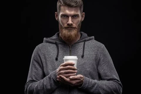 Bearded man with coffee in hand Stock Photos