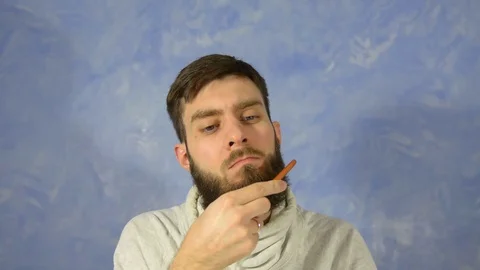 Bearded man combing his beard. Beard styling after barber shop Stock Footage 127912088