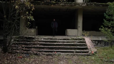 Bearded man comes out of an emergency building. devastation, broken exterior and Stock Footage 287963328