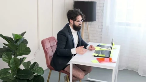 Bearded man comfortable at his desk, having a video call conference. Stock Footage 152837192