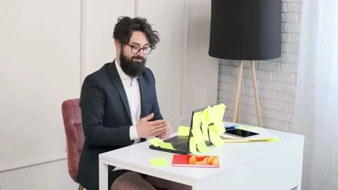 Bearded man comfortable at his desk, in underwear and jacket working remote. Stock Footage 153481766