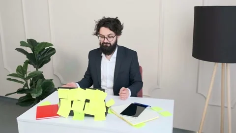 Bearded man comfortable at his desk, having a video call conference. Stock Footage 155404847