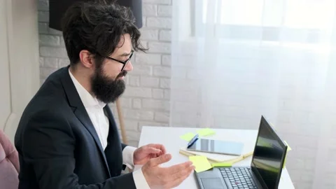 Bearded man comfortable at his desk, having a video call conference. Stock Footage 155641924