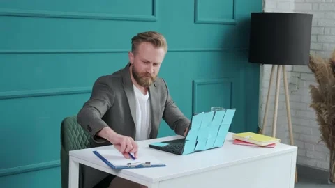 Bearded man comfortable at his desk, in underwear and jacket typing at the Stock Footage 155810941