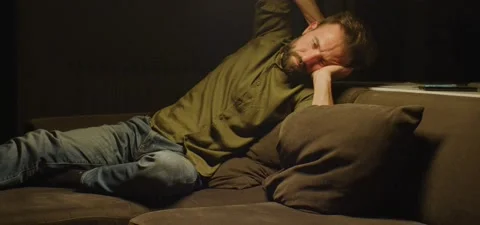 Bearded man on couch thinking, evening Stock Footage 201143348