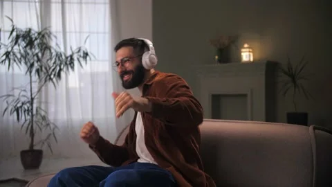 Bearded Man crazy dancing overjoyed celebration victory at home. Young guy Stock Footage 212316260