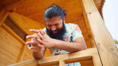 Bearded Man Cries in Silence on Rustic Deck Stock Footage 311145895