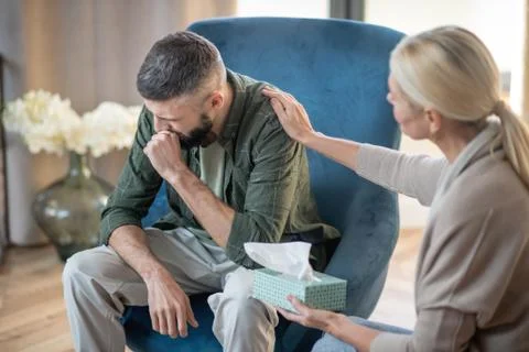 Bearded man crying while thinking about stressful childhood Stock Photos
