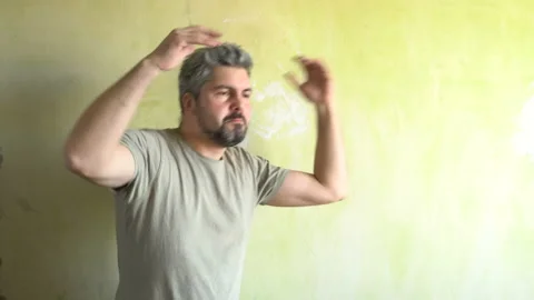 Bearded man dancing against the wall 4K Stock-Footage 126125026