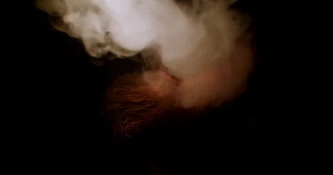 Bearded man in the dark exhales a thick smoke up Stock Footage 88059700