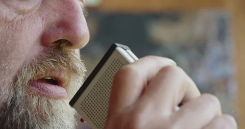 A bearded man dictates notes into a tape recorder. Close-up shot Video stock 201291138