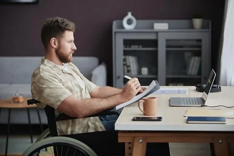 Bearded Man with Disability Coding While Working at Home Office 写真素材