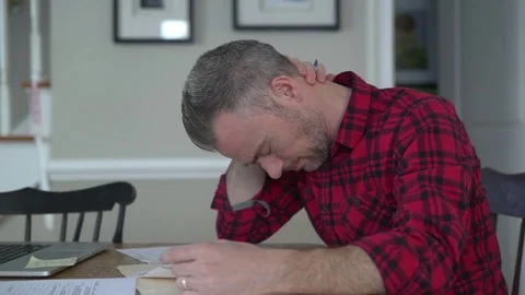 Bearded man doing paperwork Stock Footage 72612701