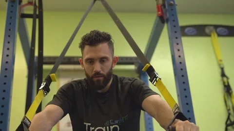Bearded man doing resistance training Stock Footage 73160836