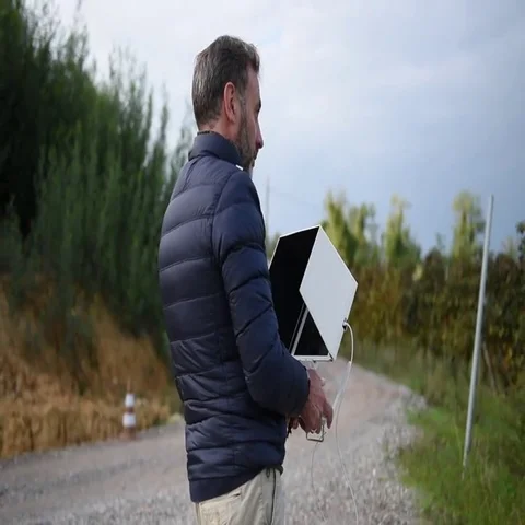 The bearded man dressed in the down jacket watching his tablet while pilo Stock-Footage 69379227