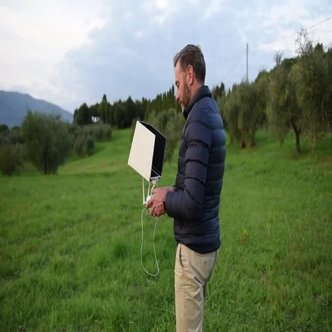 A bearded man dressed in the down jacket watching his tablet and smiling  Stock-Footage 69410445