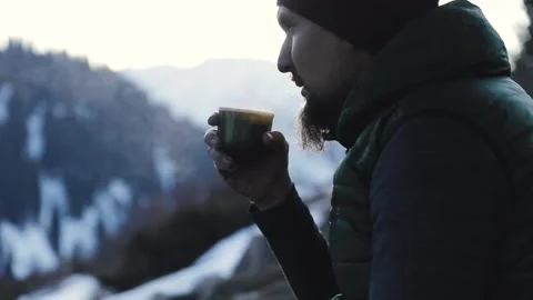 Bearded man drink coffee in winter mountains Stock Footage 167469841