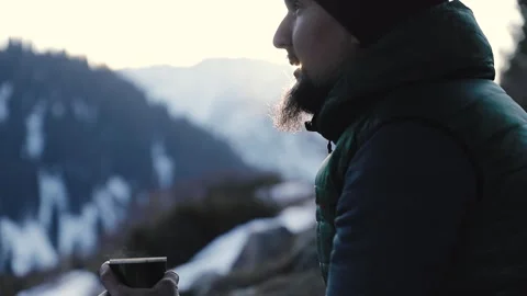 Bearded man drink coffee in winter mountains Stock Footage 167469897