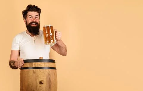 Bearded man drinking draft delicious beer at pub or bar. Craft beer at restau Stock Photos