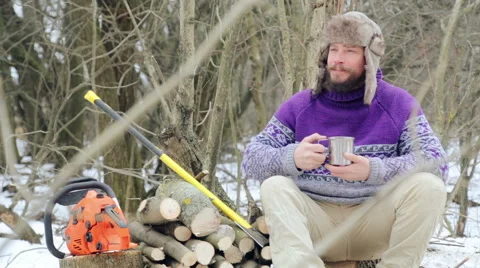 Bearded man drinking tea in the forest. Bearded woodcutter at rest in winter. Stock Footage 59608418