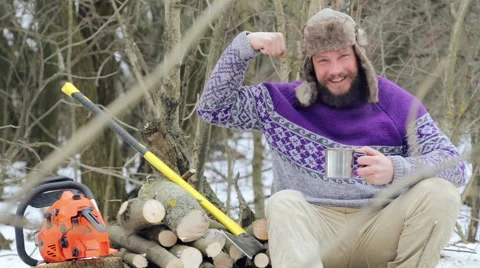 Bearded man drinking tea in the forest. Bearded woodcutter at rest in winter. Stock Footage 59611973