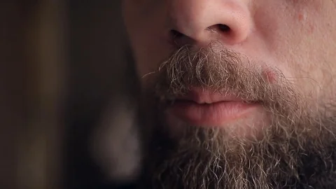 Bearded man drinking tea from iron mug, close-up, breakfast Stockbeeldmateriaal 81811030