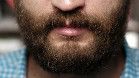 Bearded man is drinking whiskey. Male hand bring glass to his mouth and drinks Stock Footage