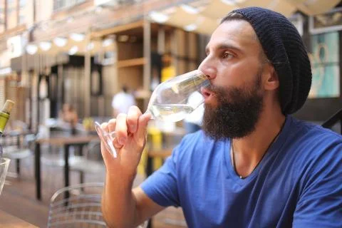 Bearded man drinking wine Stock Photos