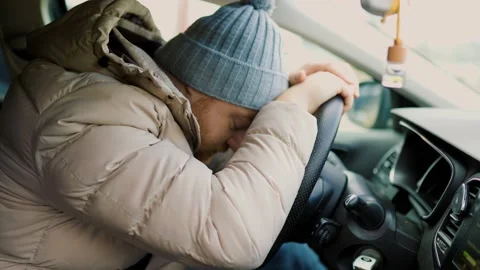 Bearded man driver, he is very tired and falls Stock Footage 234691408