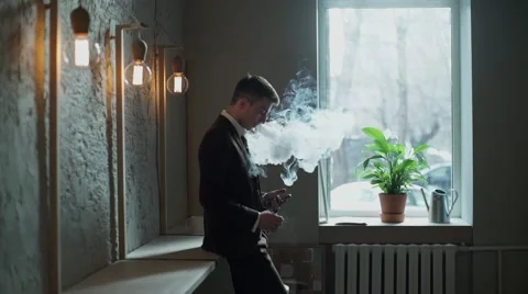 Bearded man with e-cigarette in the cafe vape vaping Stock Footage 56894965