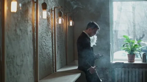 Bearded man with e-cigarette in the cafe vape vaping Stock Footage 56895259