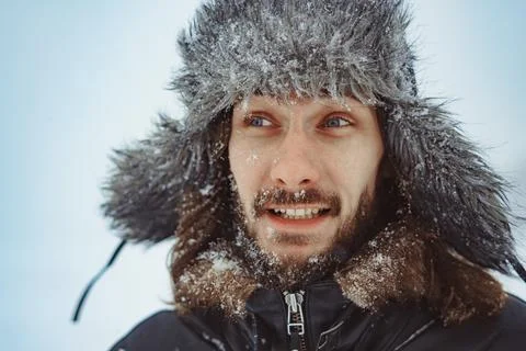 A bearded man in an earflap in winter 库存照片