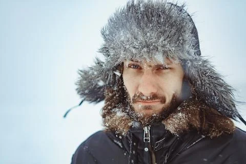 A bearded man in an earflap in winter 库存照片