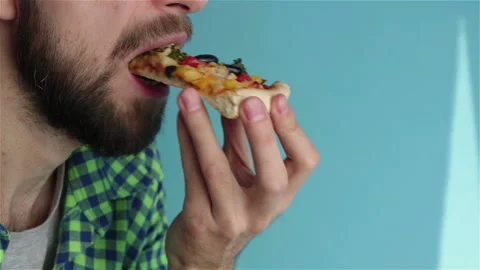Bearded  man eats  delicious vegetarian  pizza slice close up Stock Footage 122560642