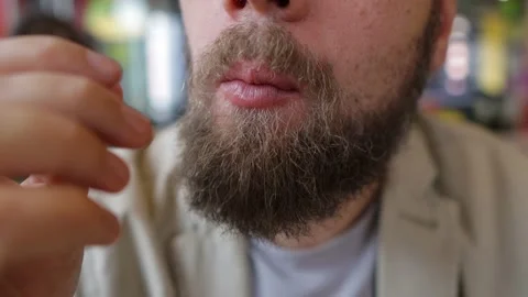 Bearded man eats fried chicken in fast food Video stock 160463625