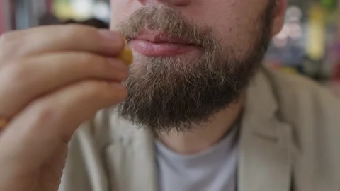 Bearded man eats fried chicken in fast food Видео 160896591