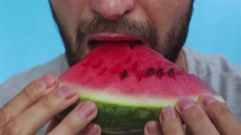Bearded man eats juicy watermelon extreme close up Stock Footage 120058207
