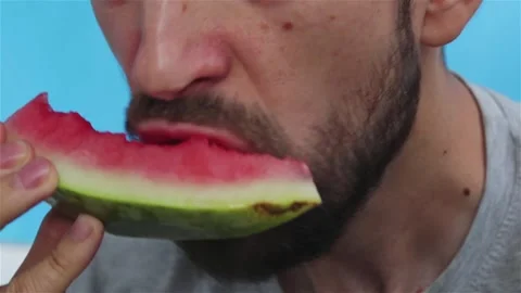 Bearded man eats juicy watermelon close up Stock Footage 154347760