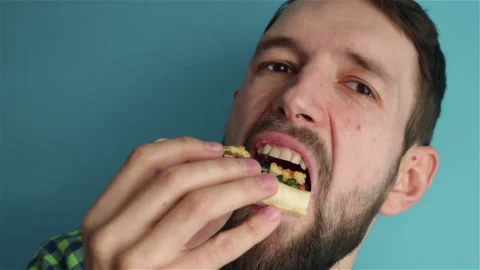 Bearded man eats a tasty vegetarian pizza slice close up Stock Footage 125460531