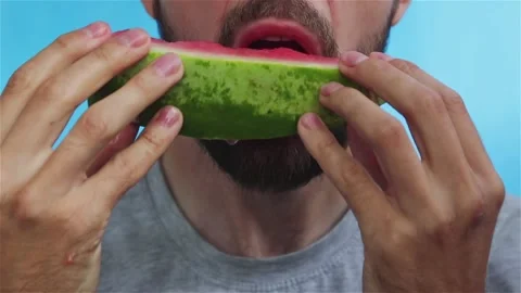 Bearded man eats watermelon close up Stock Footage 123294057