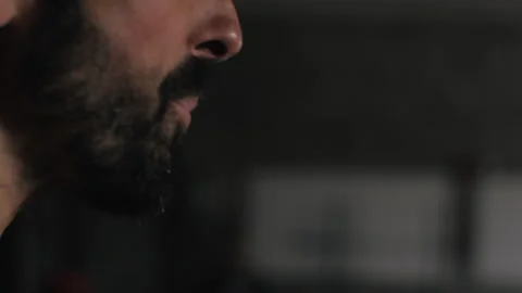 Bearded man enjoys refreshing water from cooler bottle during hot day Stock Footage 312765097