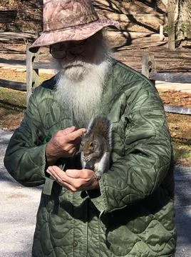 Bearded Man Feeding Squirrel Stock Photos
